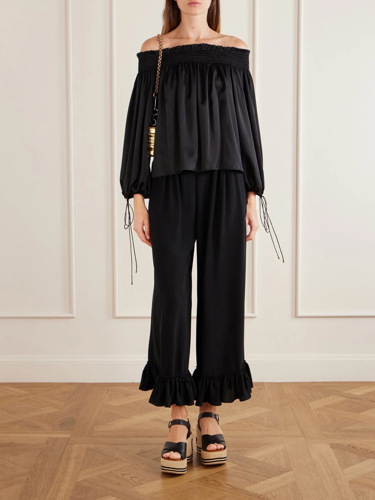 Image of a model wearing Pants. Product name - Ruffled Silk Crepe De Chine Wide-leg Pants in Black colour by brand - Chloé