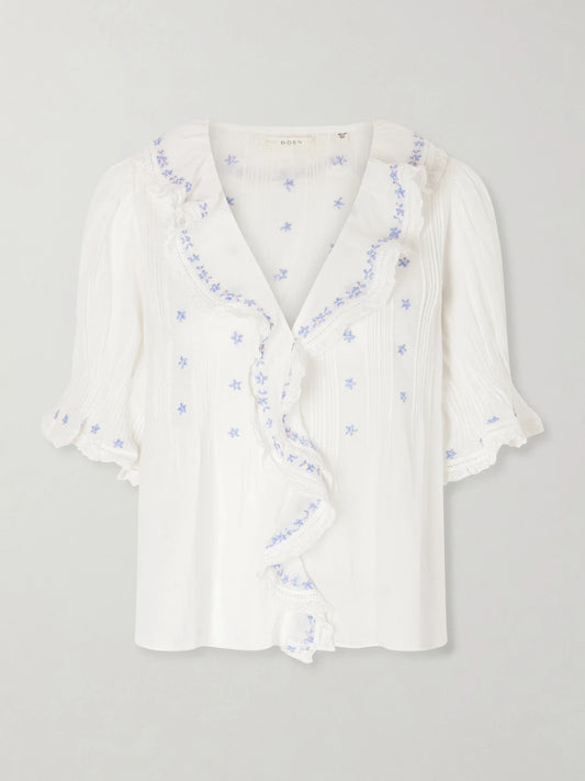 Image of a model wearing Tops. Product name - Hettie Lace-trimmed Embroidered Organic Cotton-voile Blouse in White colour by brand - DÔEN