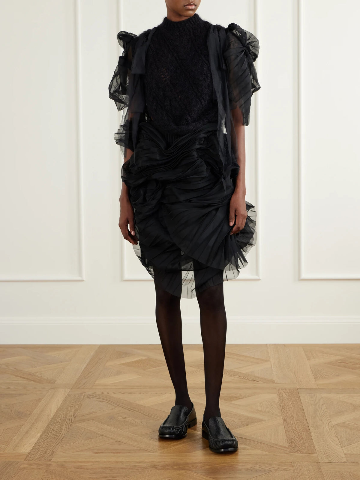 Image of a model wearing Skirts. Product name - Minna Eerie Ruched Tulle Knee-length Skirt in Black colour by brand - Pauline Dujancourt