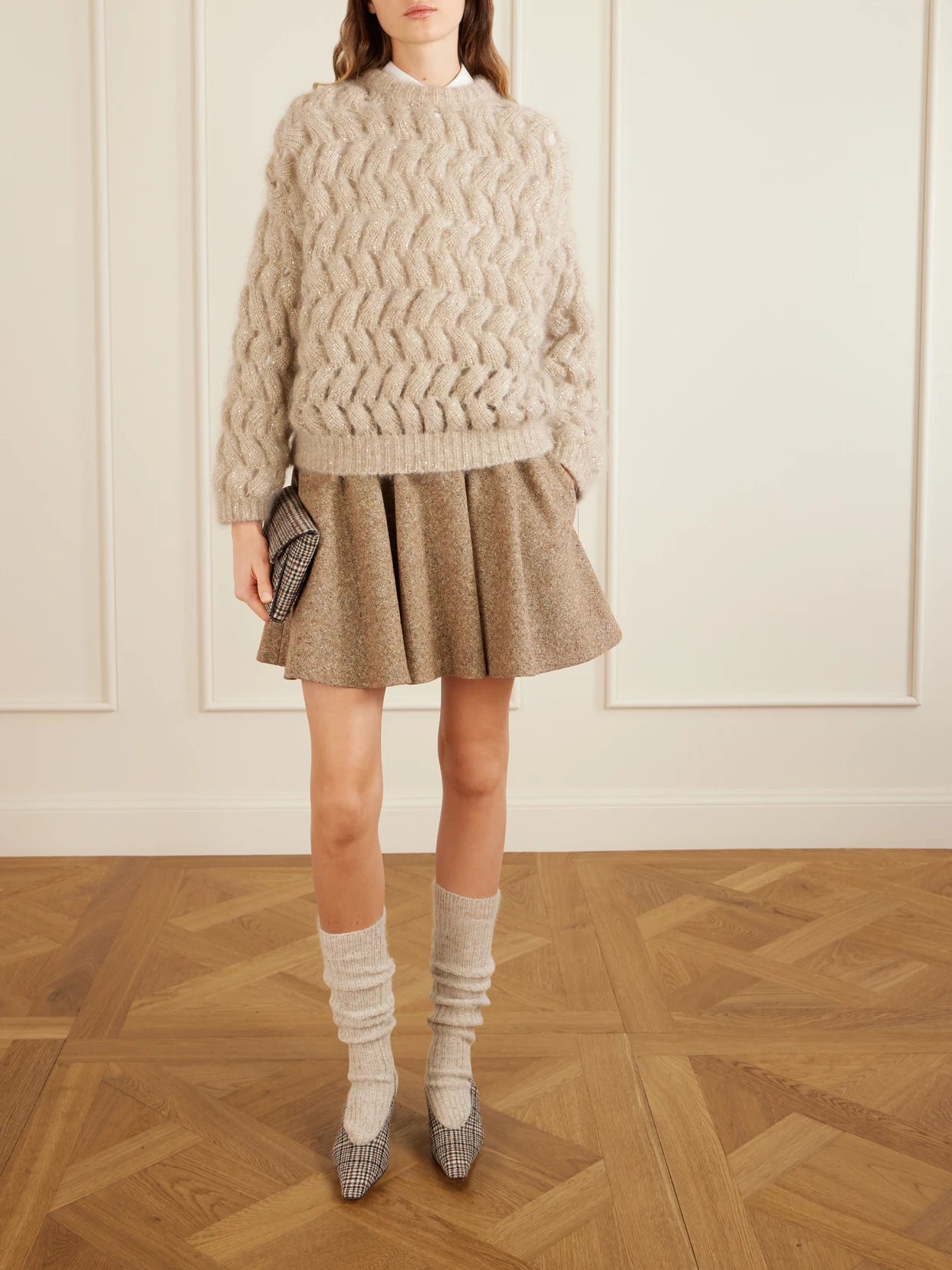 Image of a model wearing Skirts. Product name - Pleated Wool-blend Tweed Mini Skirt in Brown colour by brand - Brunello Cucinelli