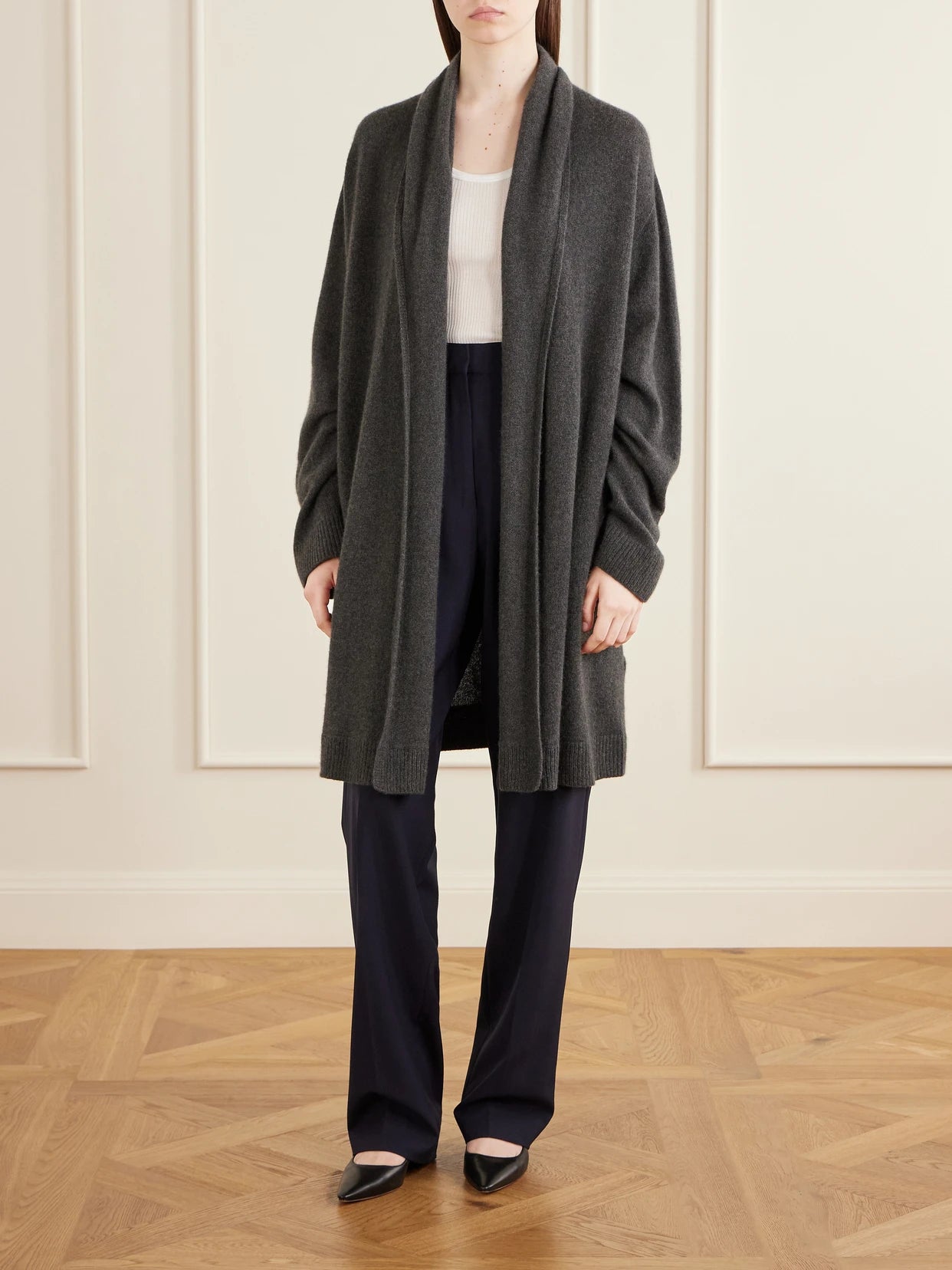 Image of a model wearing Outerwear. Product name - Ovaan Cashmere Cardigan in Anthracite colour by brand - The Row
