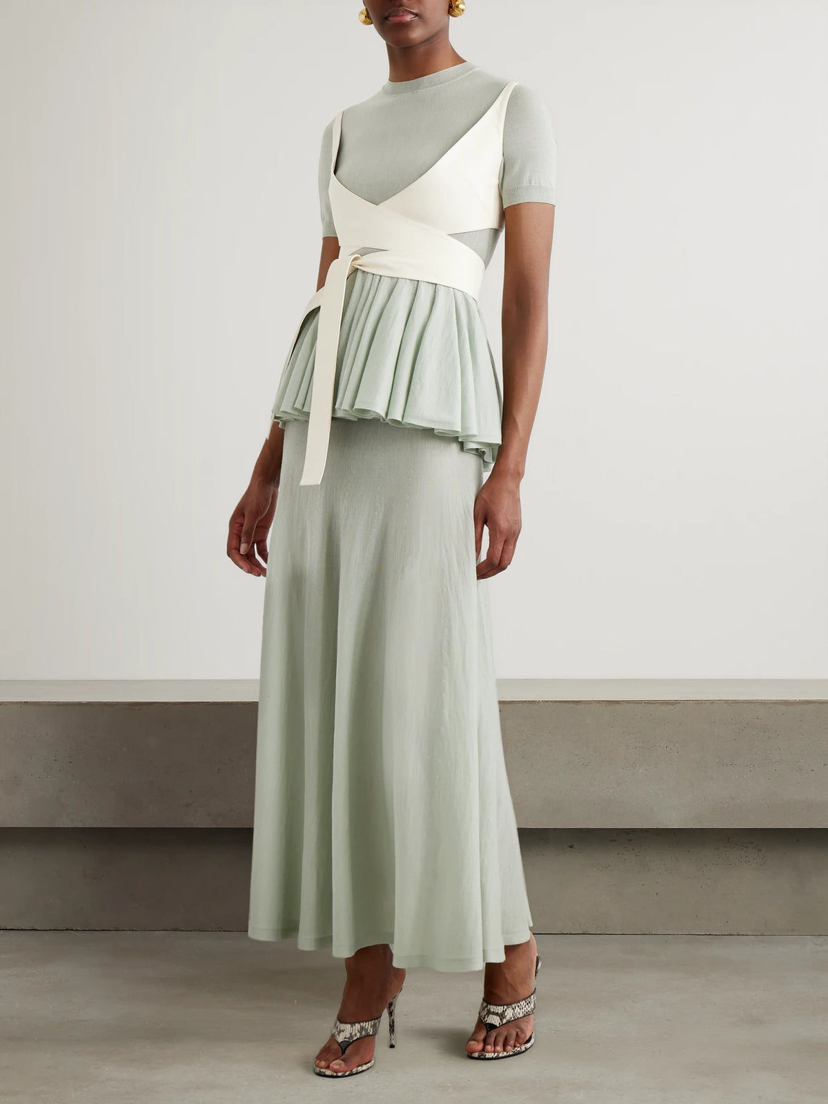 Image of a model wearing Skirts. Product name - Wool-blend Maxi Skirt in Sage green colour by brand - Alaïa