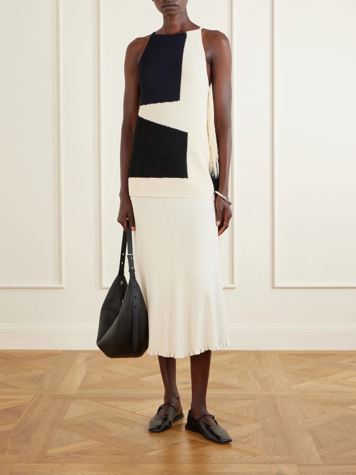 Image of a model wearing Tops. Product name - Saskia Fringed Intarsia-knit Blouse in Black colour by brand - Proenza Schouler