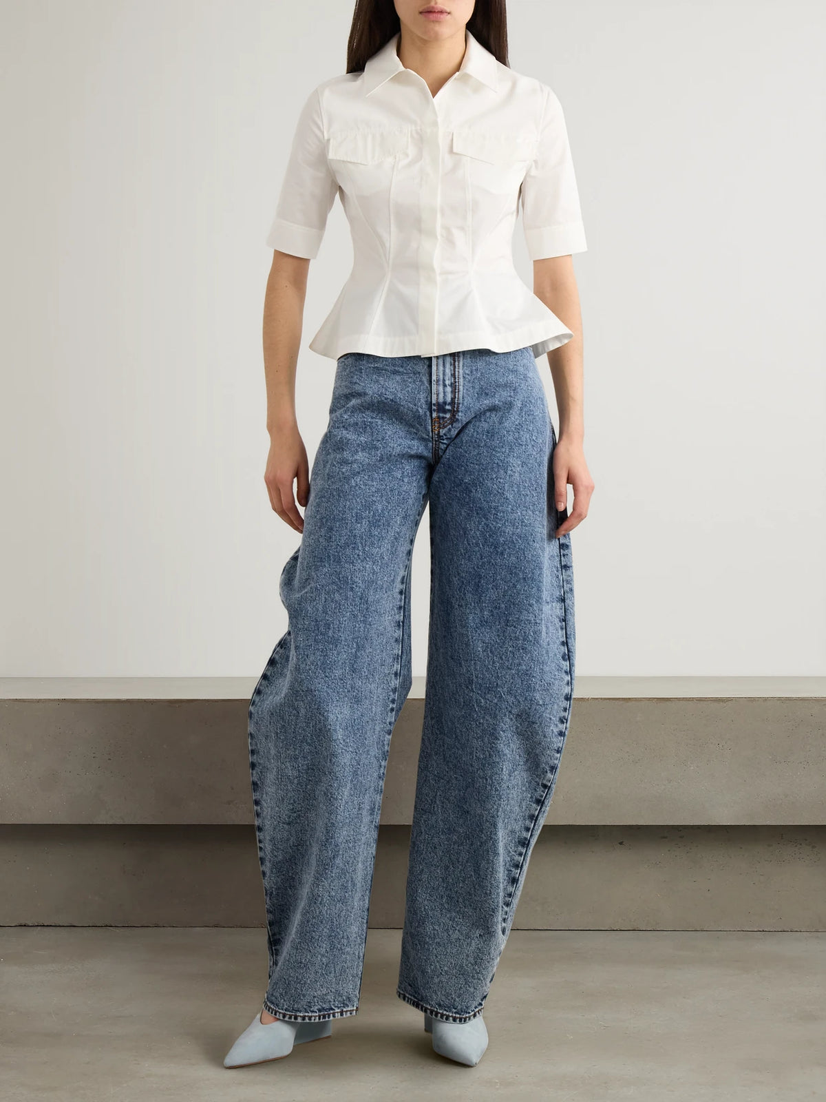Image of a model wearing Tops. Product name - Paneled Cotton-poplin Peplum Shirt in White colour by brand - Alaïa