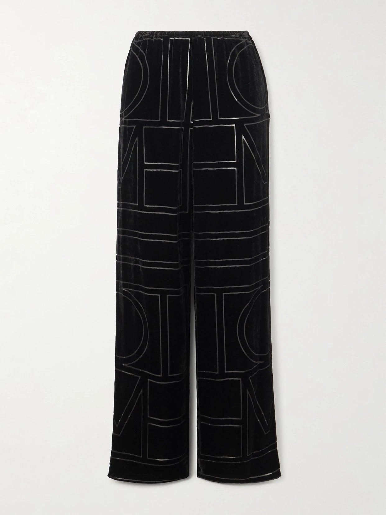 Image of a model wearing Pants. Product name - Devoré-velvet Wide-leg Pants in Black colour by brand - TOTEME