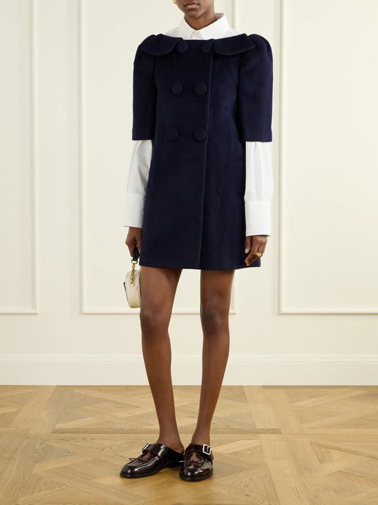 Image of a model wearing Skirts. Product name - Bow-detailed Wool-ponte Mini Skirt in Navy colour by brand - SHUSHU/TONG