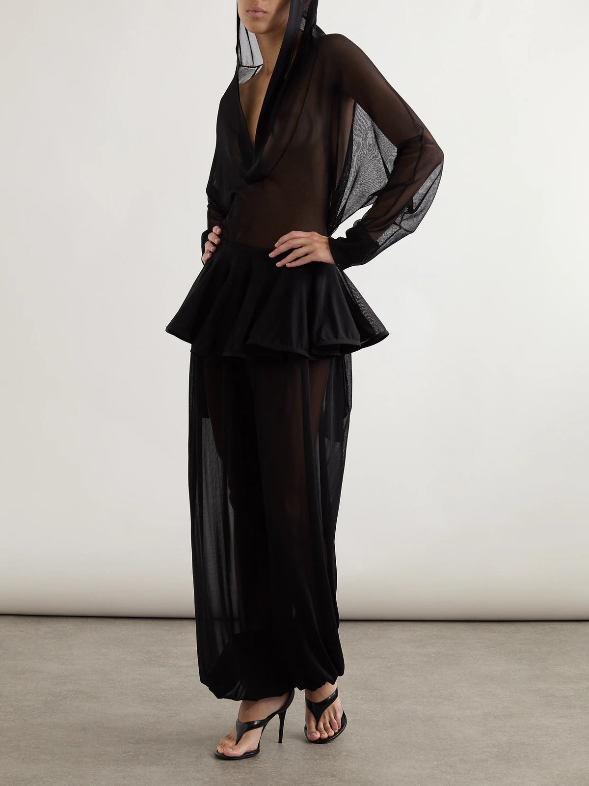 Image of a model wearing Tops. Product name - Hooded Jersey Bodysuit in Black colour by brand - Alaïa