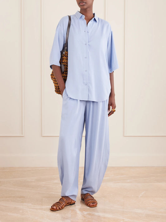 Image of a model wearing Tops. Product name - Elbow Silk Shirt in Sky blue colour by brand - Jamie Haller