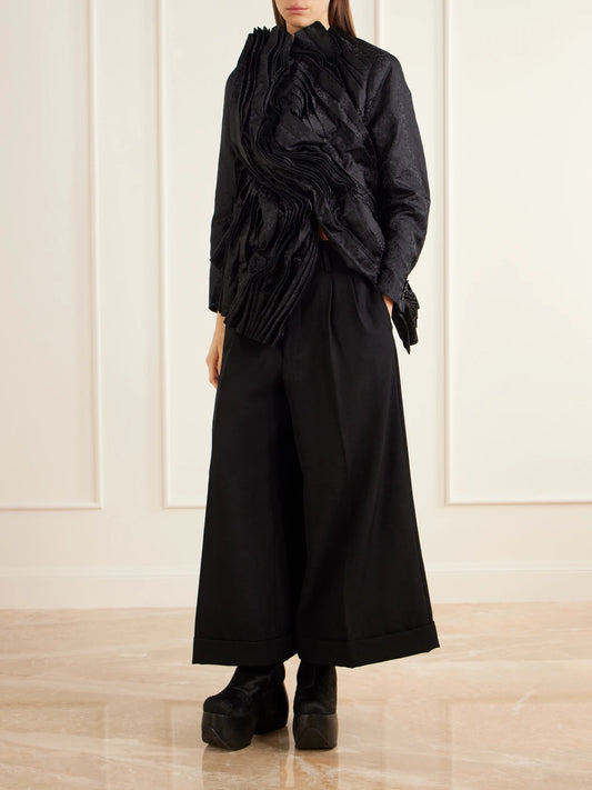 Image of a model wearing Pants. Product name - Pleated Wool-twill Wide-leg Pants in Black colour by brand - Comme des Garçons