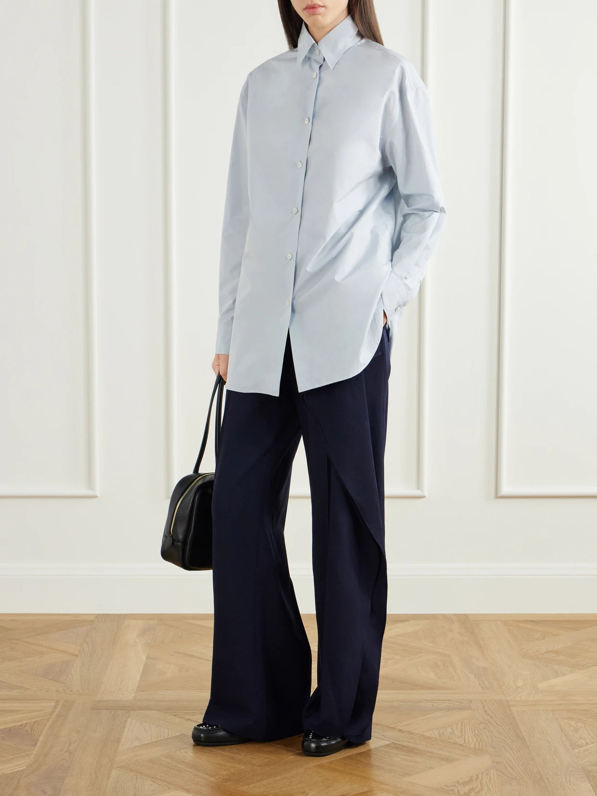Image of a model wearing Pants. Product name - Draped Wool-sablé Wide-leg Pants in Navy, Black colour by brand - Jil Sander