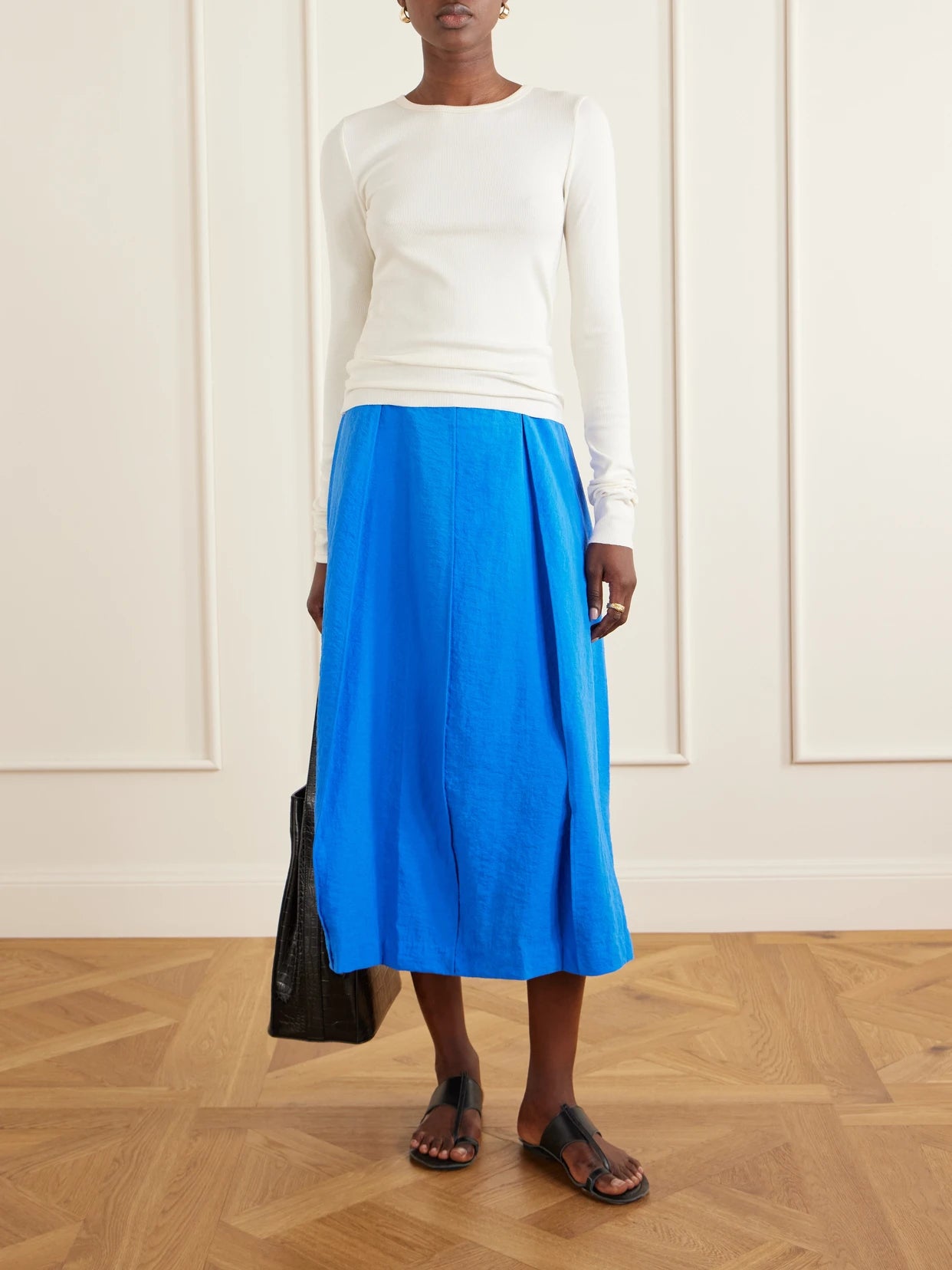 Image of a model wearing Skirts. Product name - Pleated Silk-blend Crepe Midi Skirt in Blue colour by brand - Theory