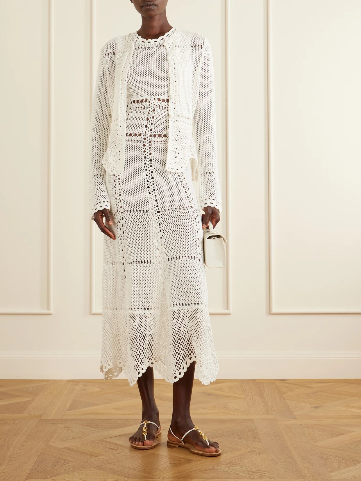 Image of a model wearing Outerwear. Product name - Crocheted Cotton Peplum Cardigan in White colour by brand - Erdem