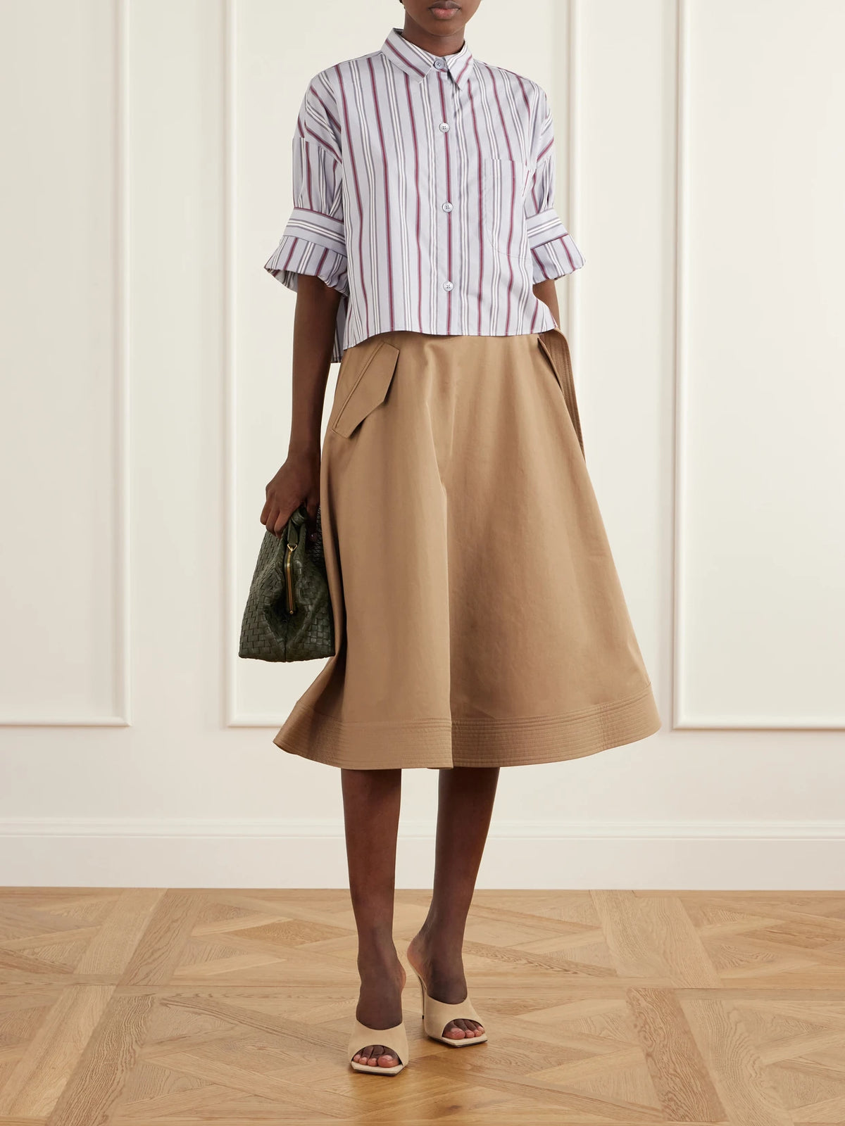 Image of a model wearing Tops. Product name - Next Ex Cropped Striped Cotton-poplin Shirt in Blue colour by brand - TWP