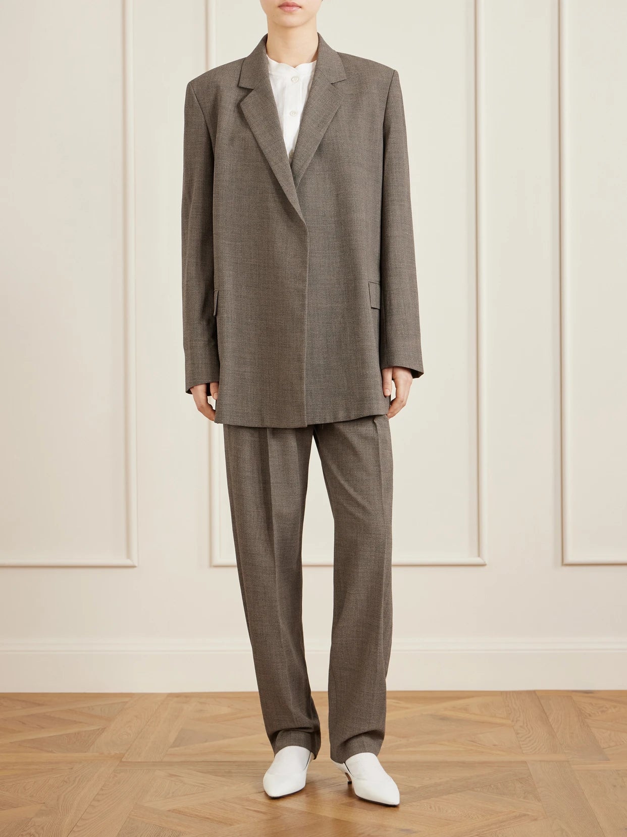 Image of a model wearing Pants. Product name - Gregori Wool Wide-leg Pants in Green colour by brand - The Row