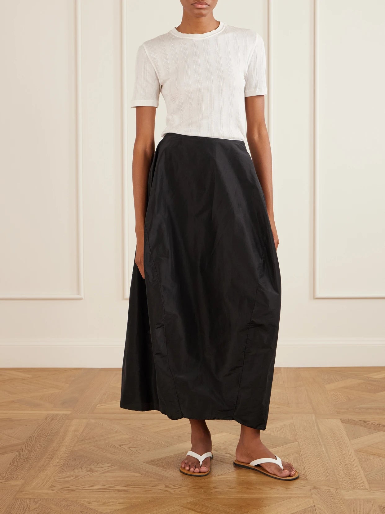 Image of a model wearing Skirts. Product name - Galyra Cotton And Silk-blend Taffeta Maxi Skirt in Black colour by brand - The Row