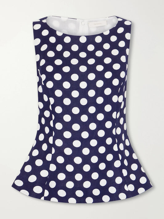 Image of a model wearing Tops. Product name - Ana Peplum Polka-dot Linen Top in Navy colour by brand - Faithfull