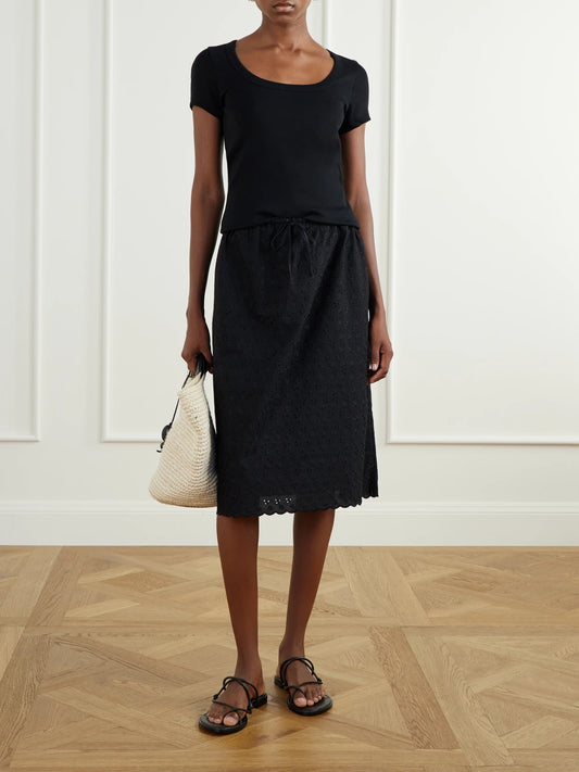 Image of a model wearing Skirts. Product name - Santana Broderie Anglaise Midi Skirt in Black colour by brand - Faithfull