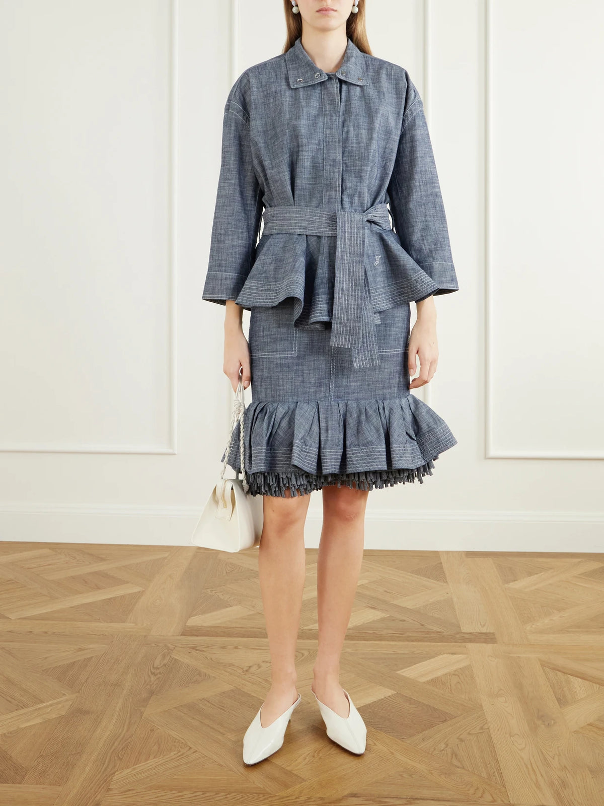 Image of a model wearing Skirts. Product name - La Jupe Cabana Fringed Ruffled Denim Mid-rise Skirt in Gray colour by brand - Jacquemus