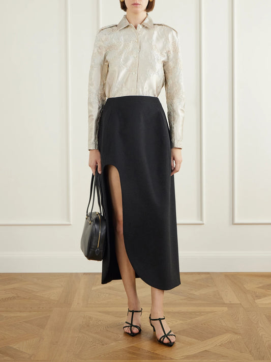 Image of a model wearing Skirts. Product name - Wool Cut-out Midi Skirt in Black colour by brand - Jil Sander