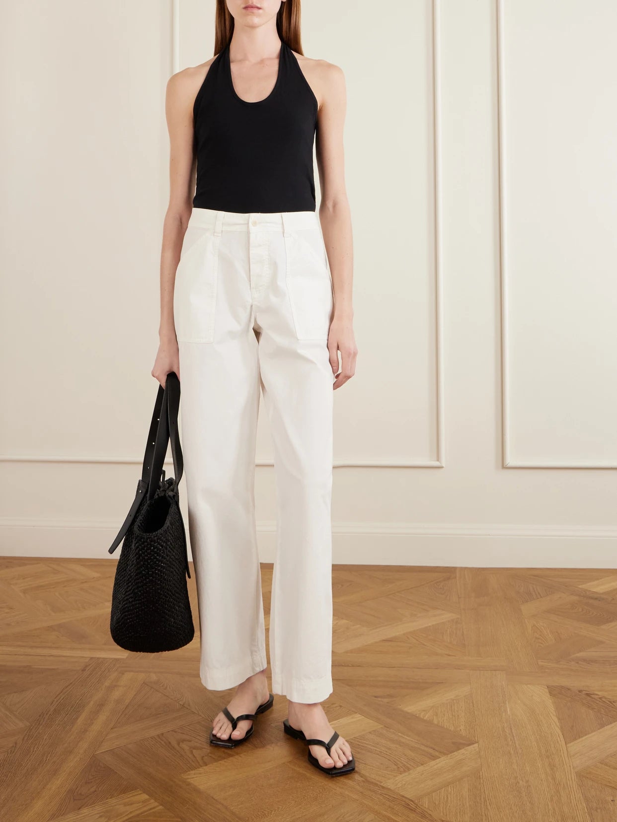 Image of a model wearing Tops. Product name - Tie-detailed Cotton-jersey Halterneck Tank in Black colour by brand - Matteau