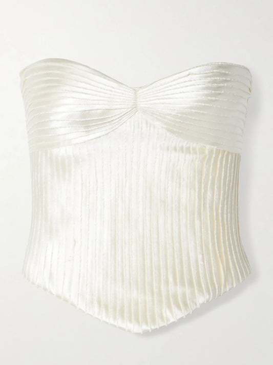 Image of a model wearing Tops. Product name - Ella Strapless Frayed Pintucked Silk And Wool-blend Satin Bustier Top in Off-white colour by brand - Danielle Frankel