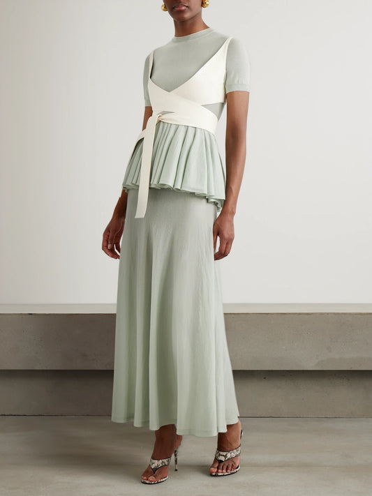 Image of a model wearing Tops. Product name - Wool Peplum Top in Gray green colour by brand - Alaïa