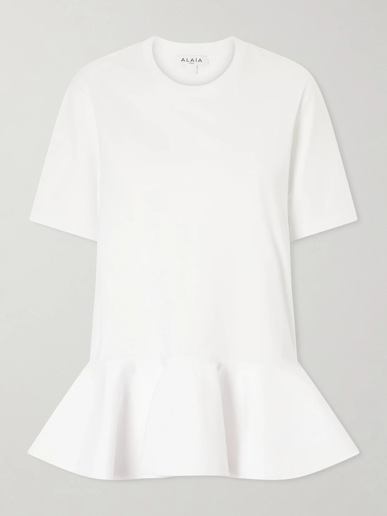 Image of a model wearing Tops. Product name - Peplum Cotton-jersey T-shirt in White colour by brand - Alaïa