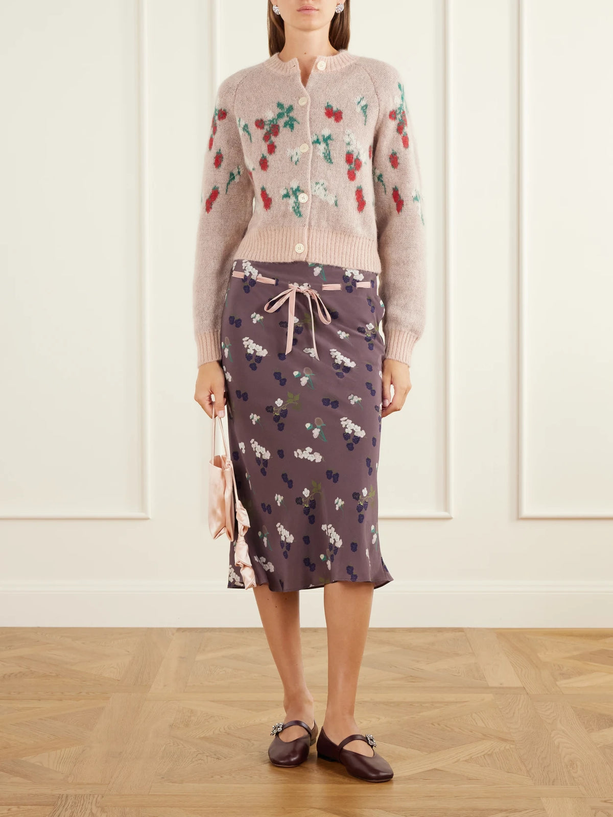 Image of a model wearing Skirts. Product name - Camille Floral-print Velvet-trimmed Silk-habotai Drawstring Midi Skirt in Dark purple colour by brand - BERNADETTE