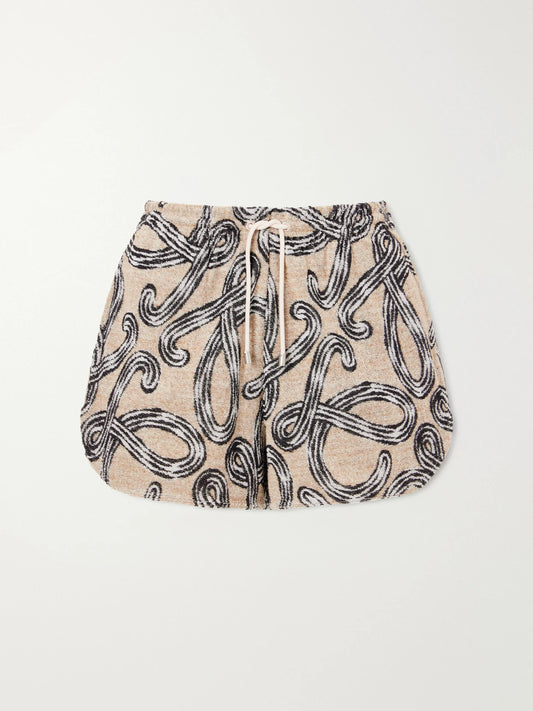 Image of a model wearing Shorts. Product name - +paula's Ibiza Printed Cotton-blend Terry Shorts in Beige colour by brand - LOEWE