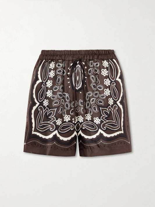 Image of a model wearing Shorts. Product name - Frances Bandana-print Silk-twill Shorts in Brown colour by brand - Nili Lotan