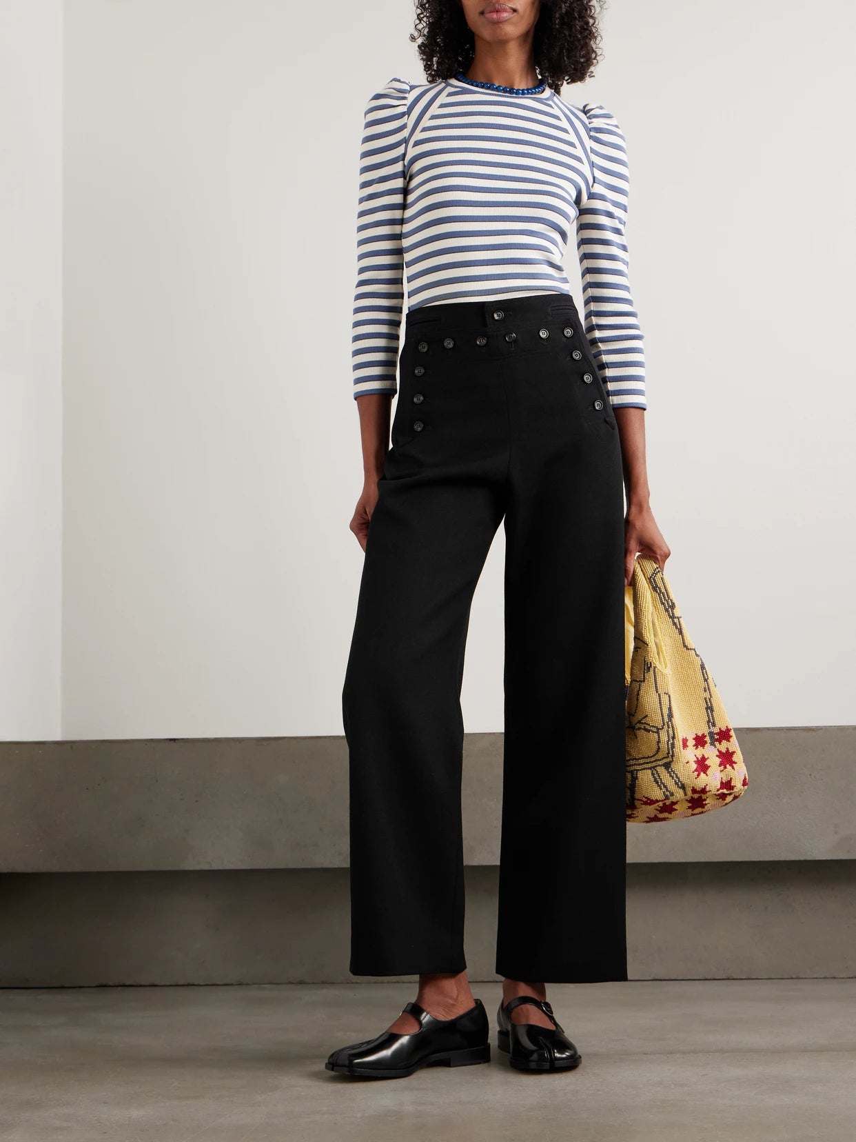 Image of a model wearing Pants. Product name - Sailor Wool-twill Straight-leg Pants in Black colour by brand - BODE