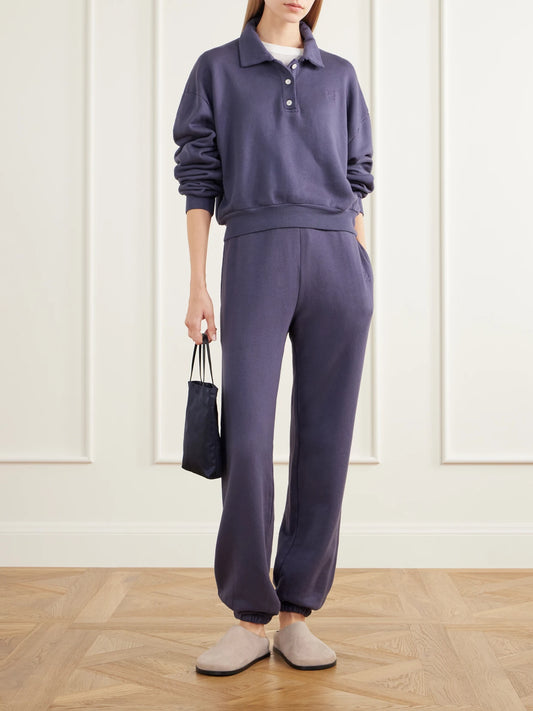 Image of a model wearing Tops. Product name - Cropped Cotton And Modal-blend Terry Polo Sweatshirt in Navy colour by brand - ÉTERNE