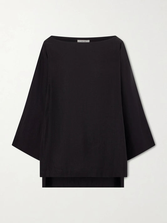 Image of a model wearing Tops. Product name - Junia Oversized Linen Blouse in Black colour by brand - The Row