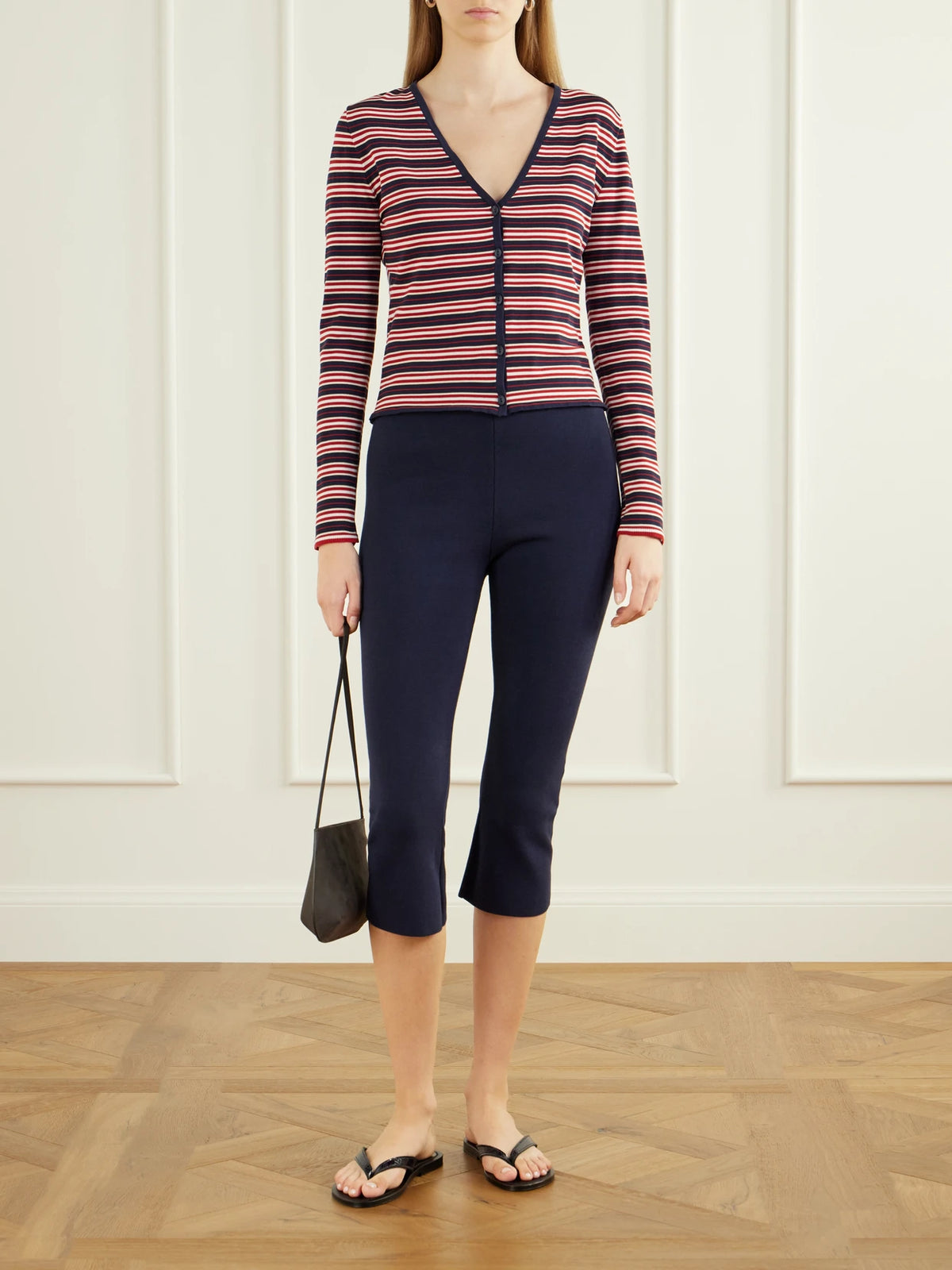 Image of a model wearing Outerwear. Product name - Doris Striped Cotton-blend Cardigan in Navy colour by brand - Faithfull