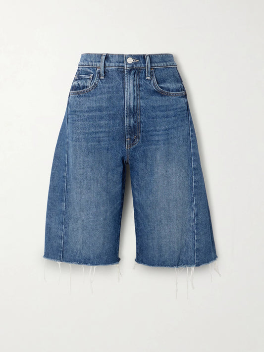 Image of a model wearing Shorts. Product name - The Half Pipe Bermuda Fray Denim Shorts in Mid denim colour by brand - Mother