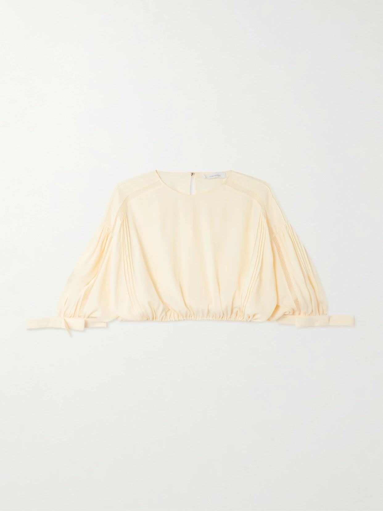 Image of a model wearing Tops. Product name - Cropped Bow-detailed Lace-trimmed Pleated Crepe Top in Ecru colour by brand - RABANNE