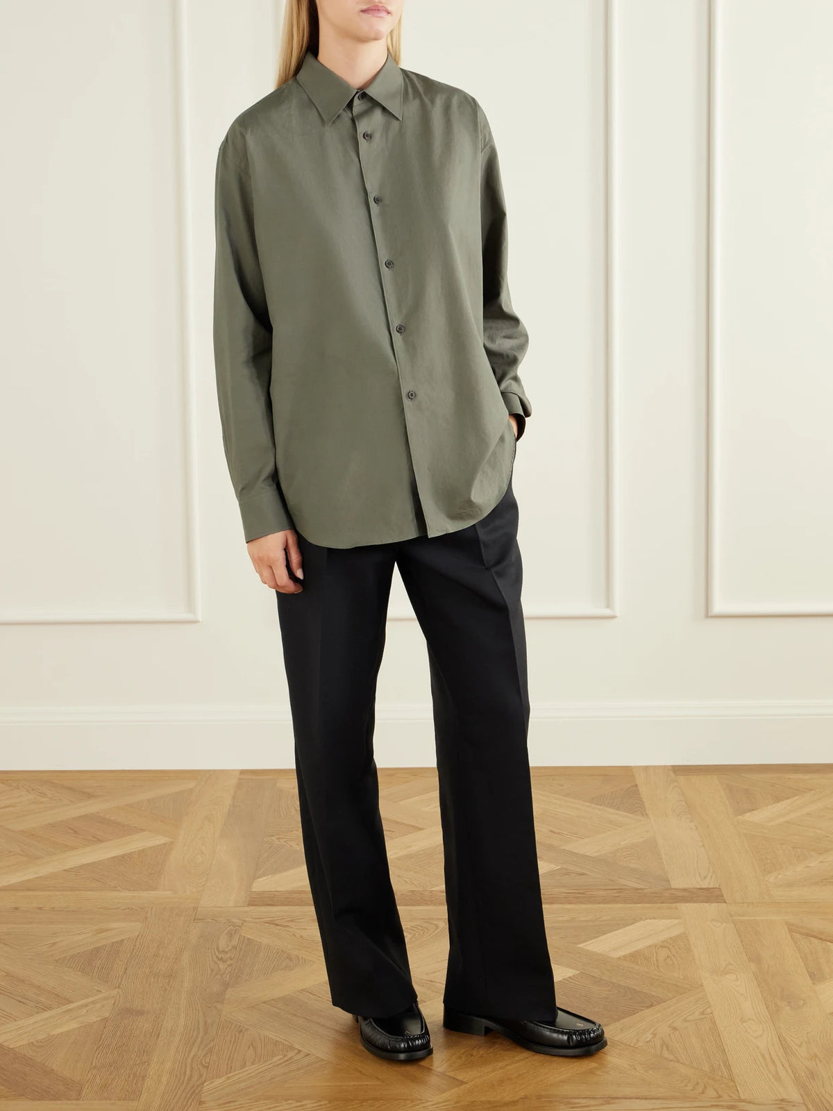 Image of a model wearing Tops. Product name - Cotton-twill Shirt in Army green colour by brand - Auralee