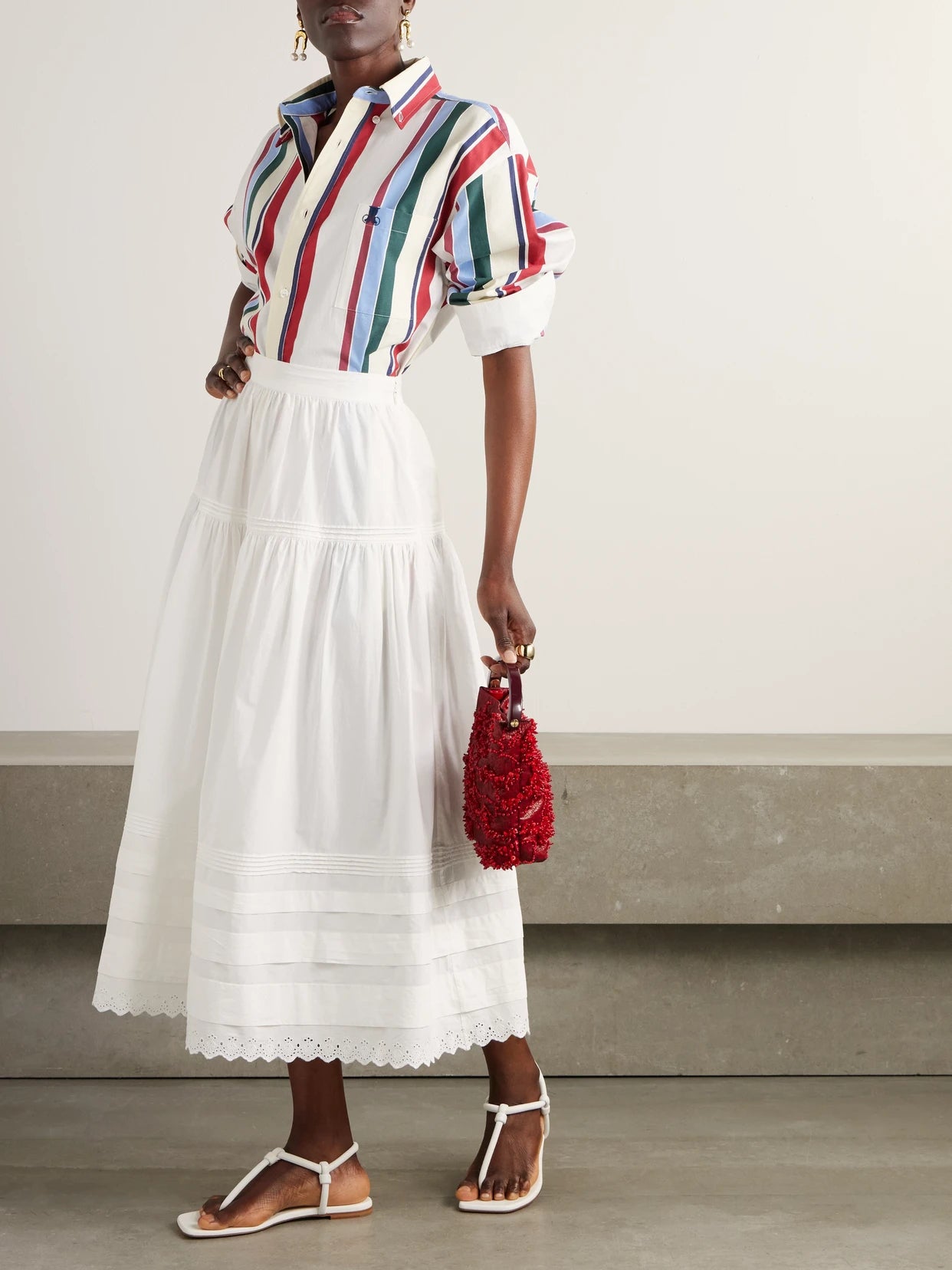 Image of a model wearing Skirts. Product name - Sebastiane Broderie Anglaise-trimmed Organic Cotton-poplin Midi Skirt in White colour by brand - DÔEN