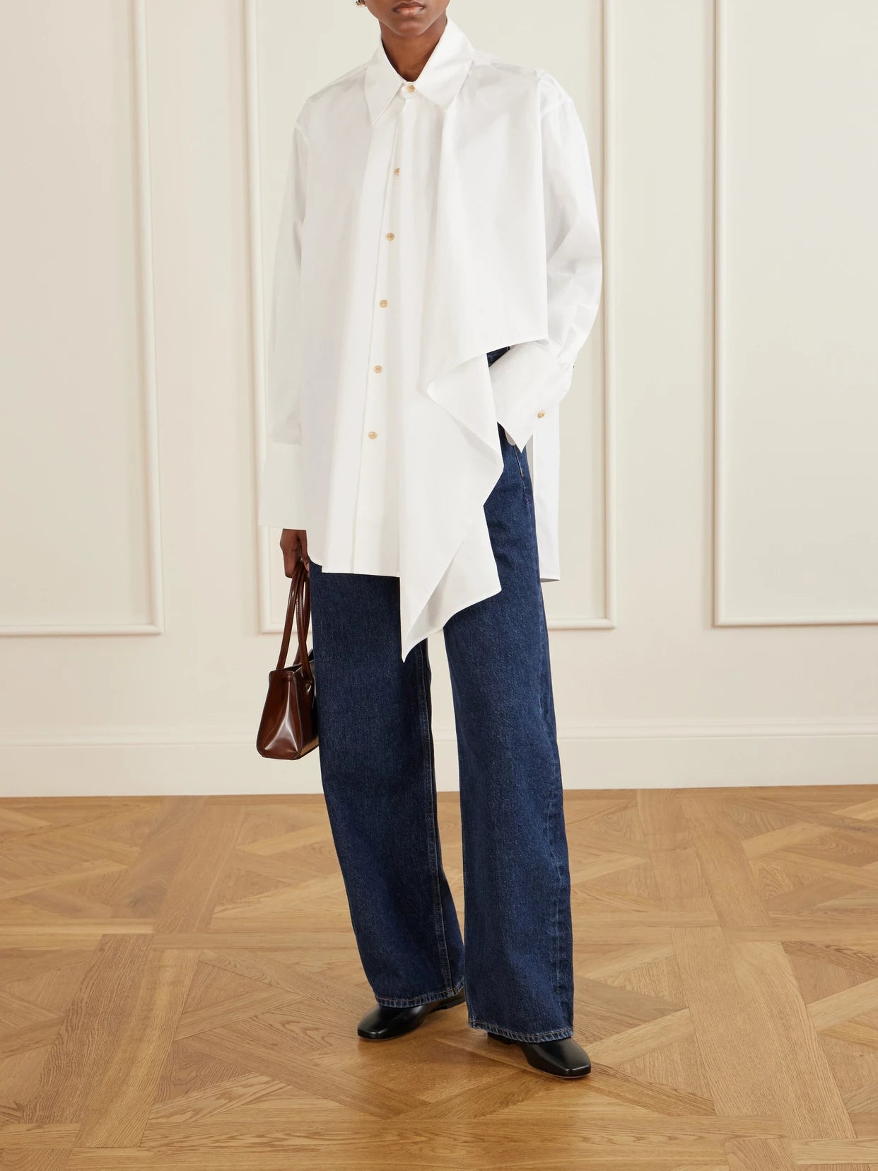 Image of a model wearing Tops. Product name - Tess Draped Cotton Poplin Shirt in Off-white colour by brand - OSSOU