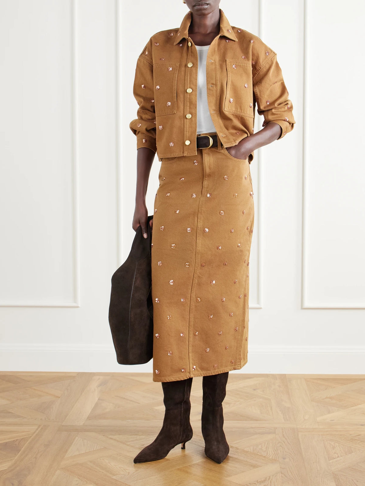 Image of a model wearing Skirts. Product name - The Verona Sequin-embellished Denim Midi Skirt in Brown colour by brand - Ulla Johnson