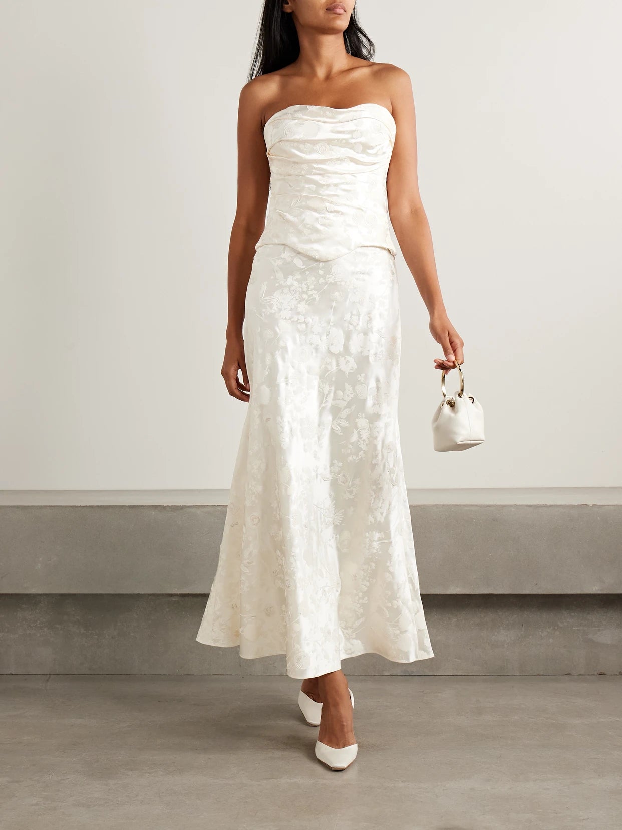 Image of a model wearing Skirts. Product name - Desi Painted Silk And Wool-blend Satin Maxi Skirt in Off-white colour by brand - Danielle Frankel