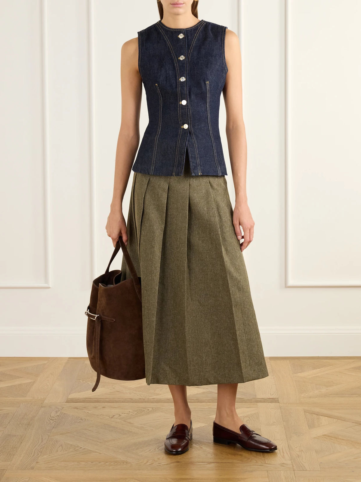 Image of a model wearing Outerwear. Product name - The Form Denim Vest in Dark denim colour by brand - FRAME