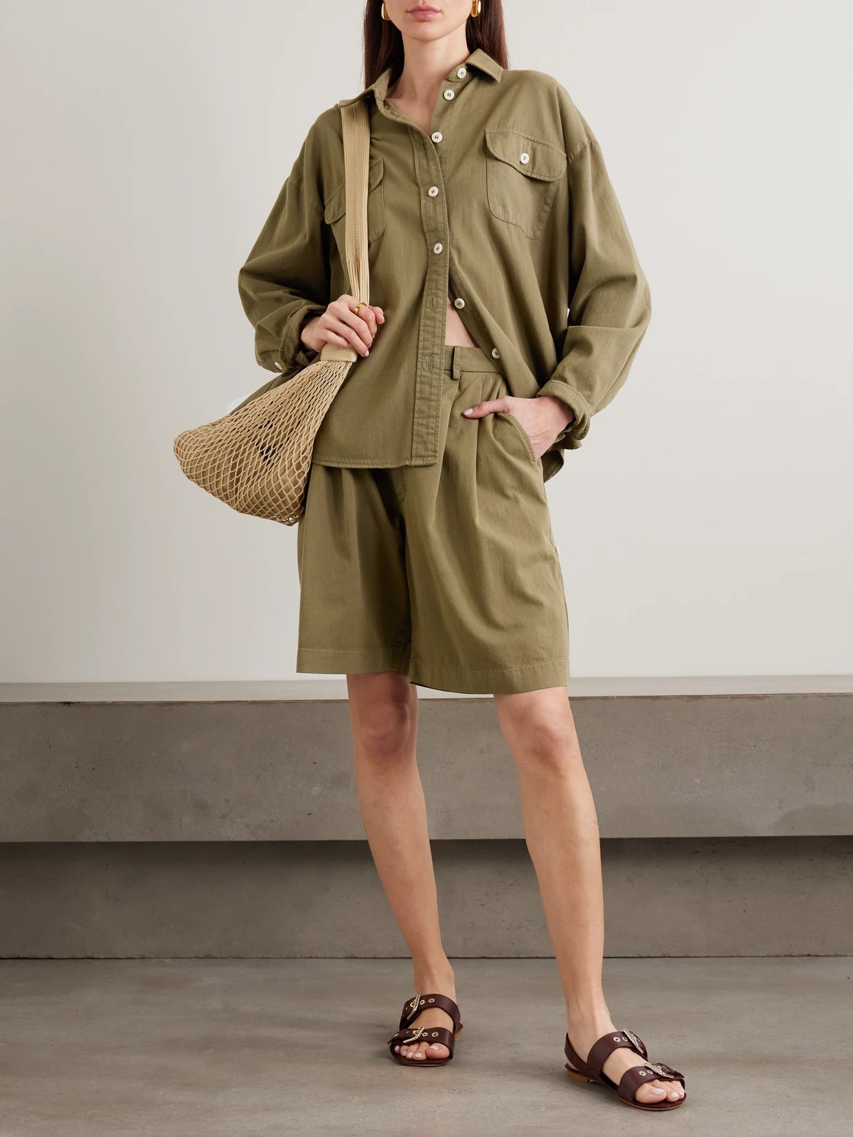 Image of a model wearing Tops. Product name - The Big Oversized Cotton-twill Shirt in Army green colour by brand - Jamie Haller