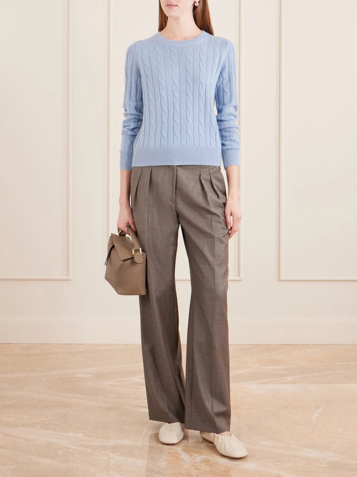 Image of a model wearing Outerwear. Product name - Silvie Cable-knit Cashmere Sweater in Light blue colour by brand - Nili Lotan