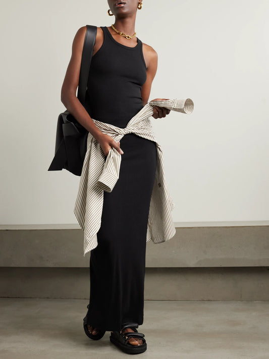 Image of a model wearing Skirts. Product name - Emma Ribbed Stretch-jersey Maxi Skirt in Black colour by brand - ÉTERNE