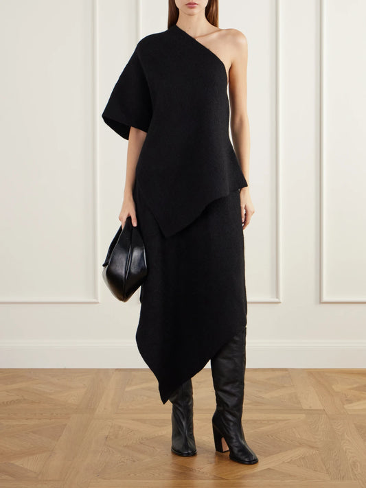 Image of a model wearing Tops. Product name - Manta One-shoulder Asymmetric Merino Wool, Alpaca And Cotton-blend Blouse in Black colour by brand - Lauren Manoogian
