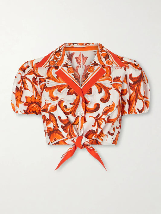 Image of a model wearing Tops. Product name - Cropped Printed Cotton-poplin Top in Orange colour by brand - Dolce & Gabbana