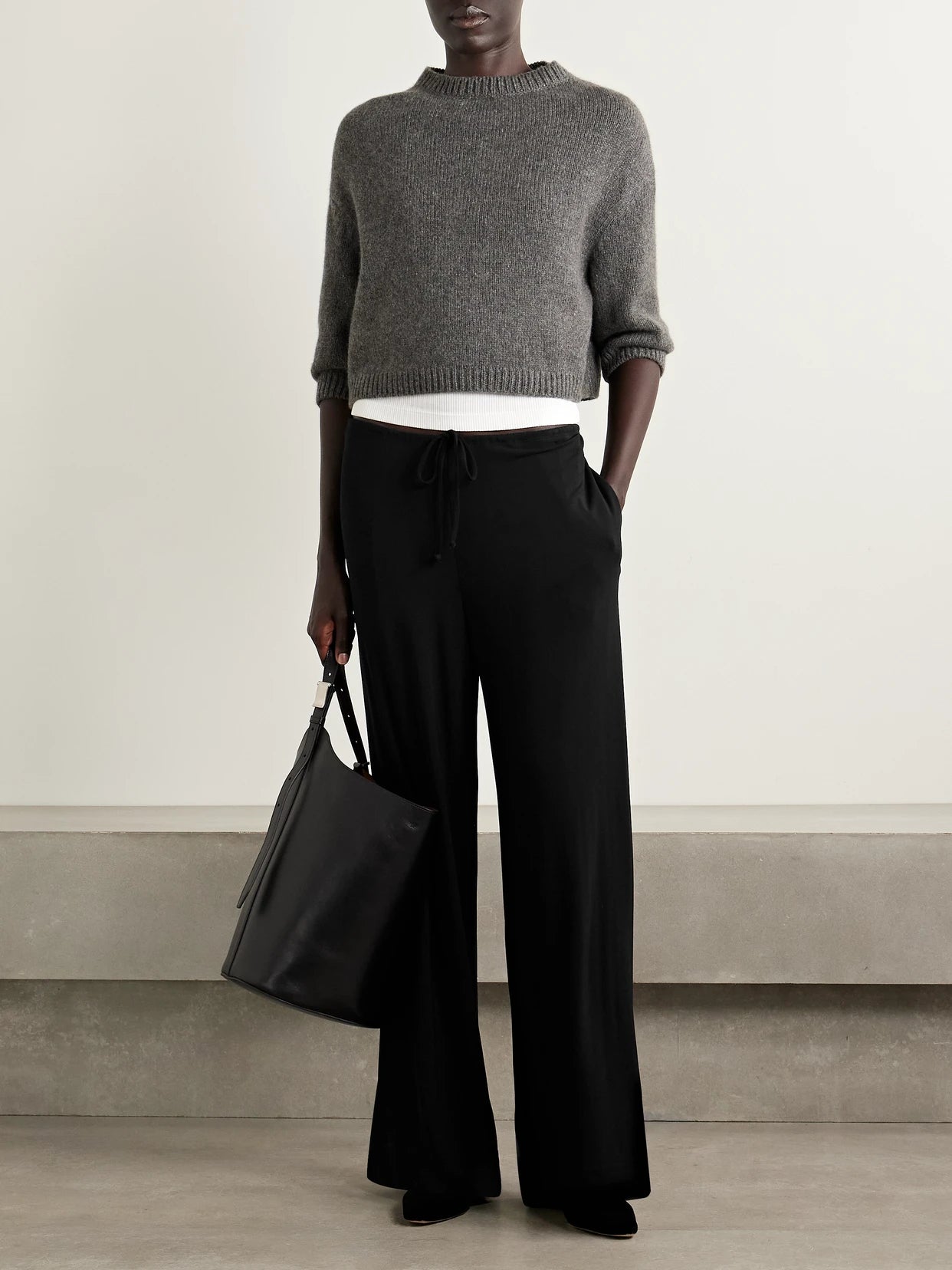 Image of a model wearing Pants. Product name - Adriel Stretch-jersey Wide-leg Pants in Black colour by brand - Nili Lotan