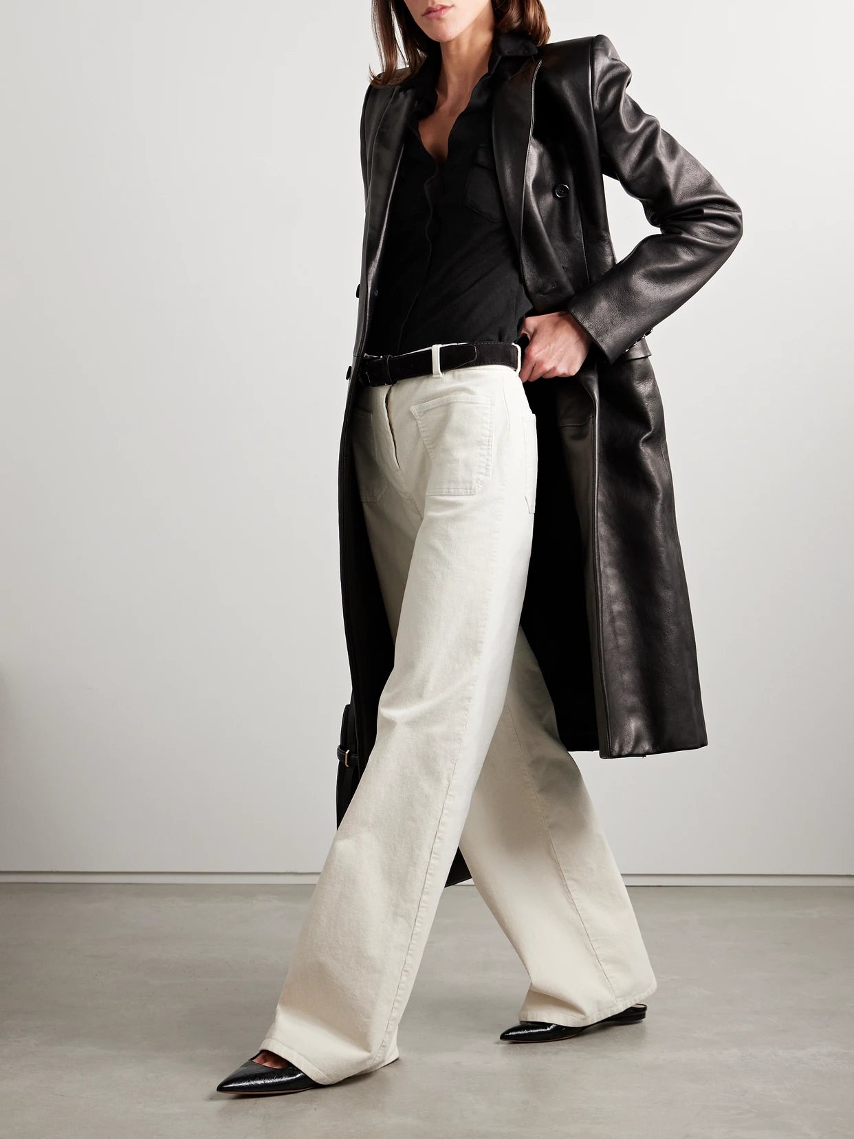 Image of a model wearing Tops. Product name - Liam Cotton-jersey Shirt in Black colour by brand - Nili Lotan