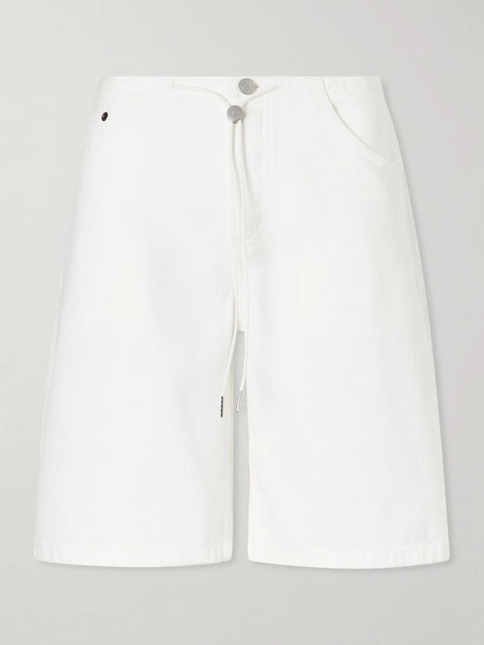Image of a model wearing Shorts. Product name - Low-rise Denim Shorts in White colour by brand - Still Here